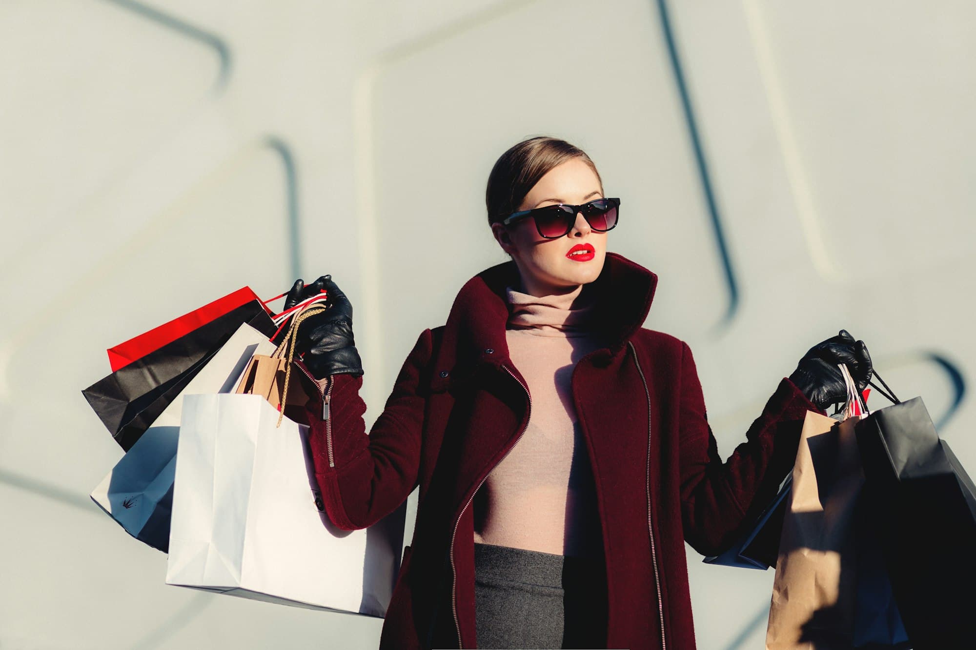 photo of woman in fancy clothes holding multiple shopping bags