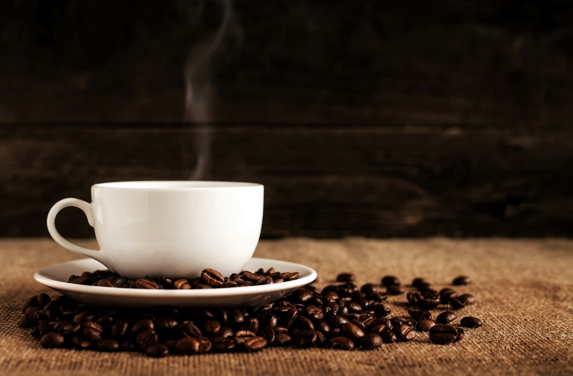 Coffee cup with roasted coffee beans.