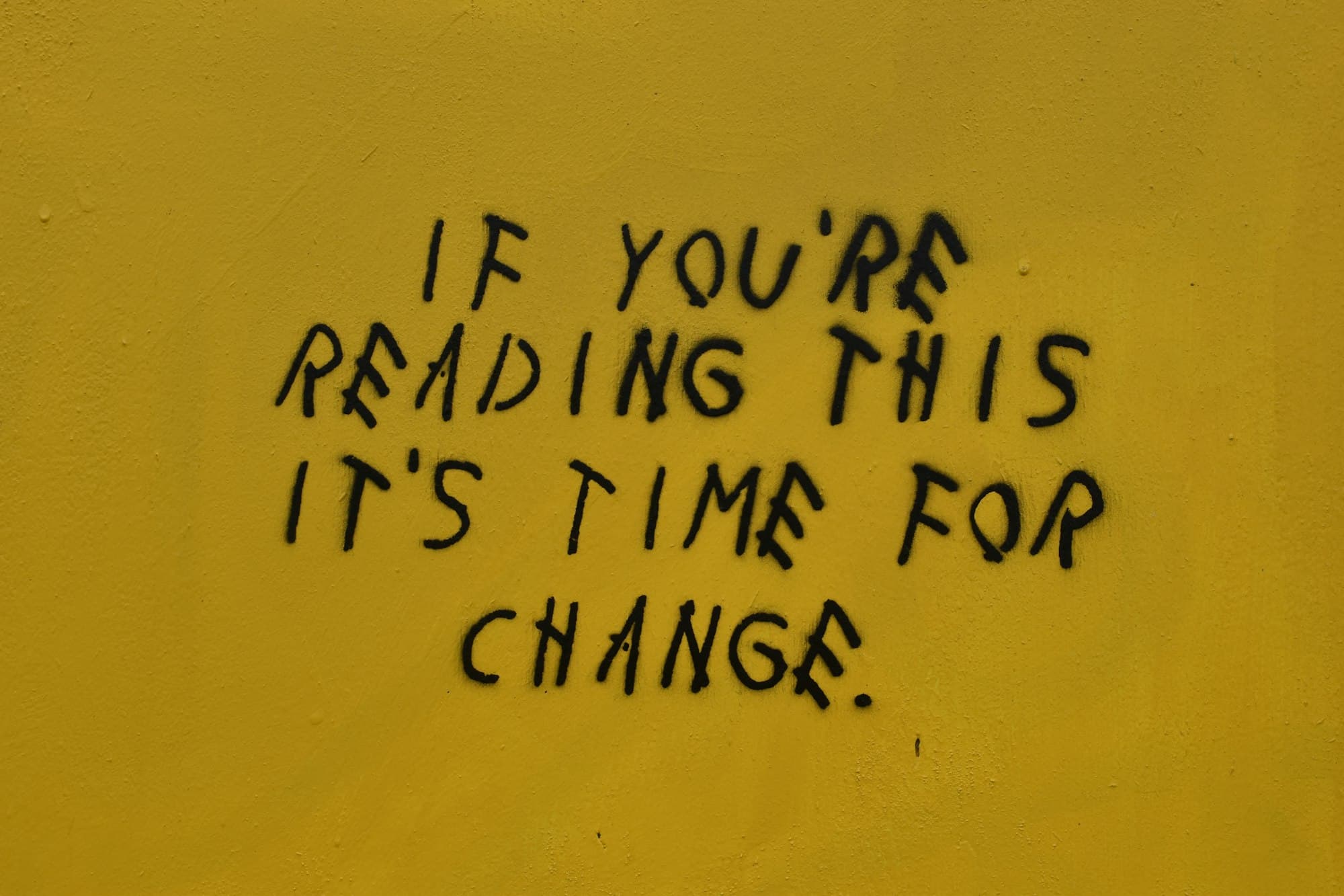 spraypaint text reading, "If you're reading this, it's time for change"