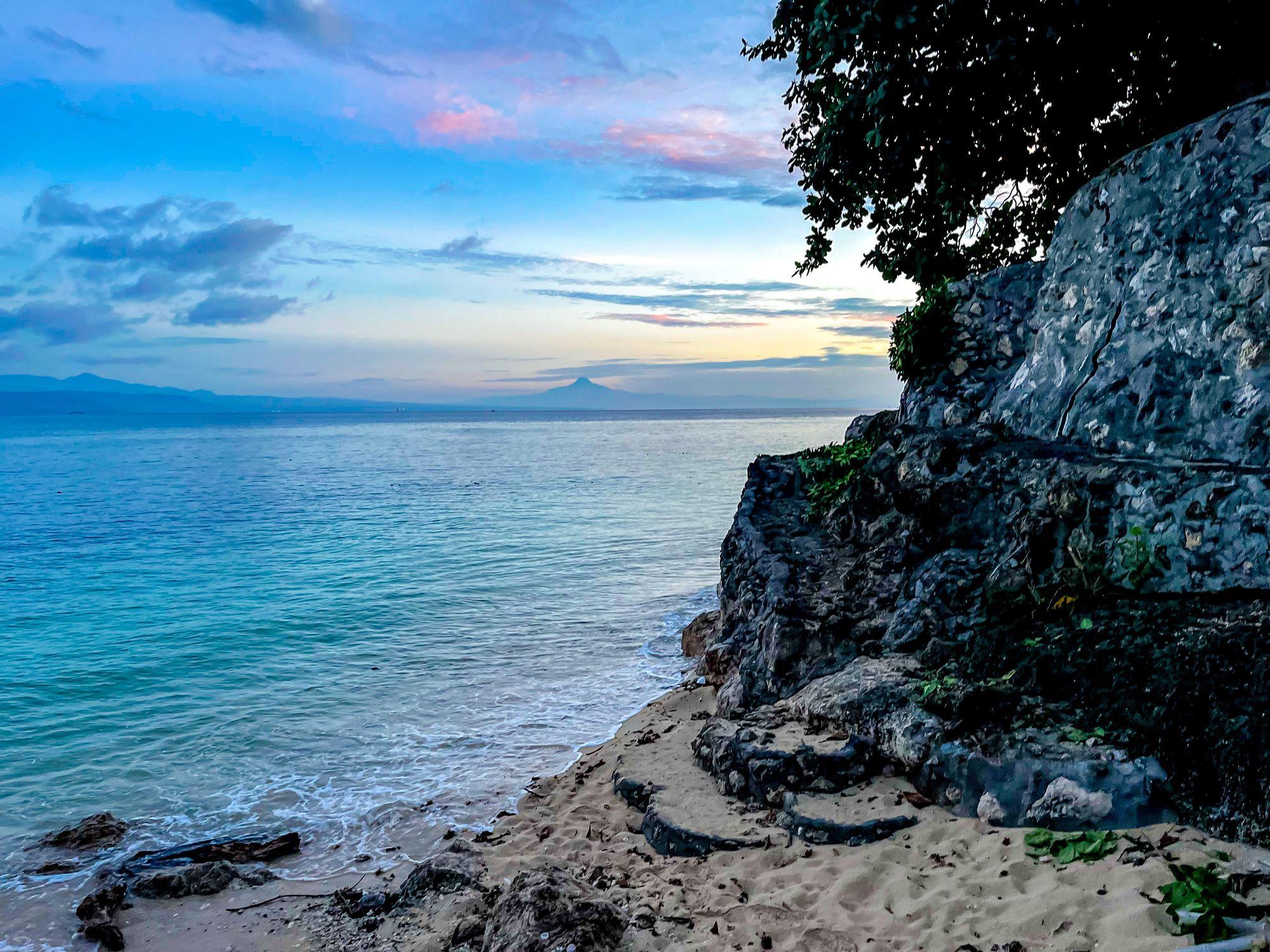 Sunrise near a rocky beach in the Philippines.