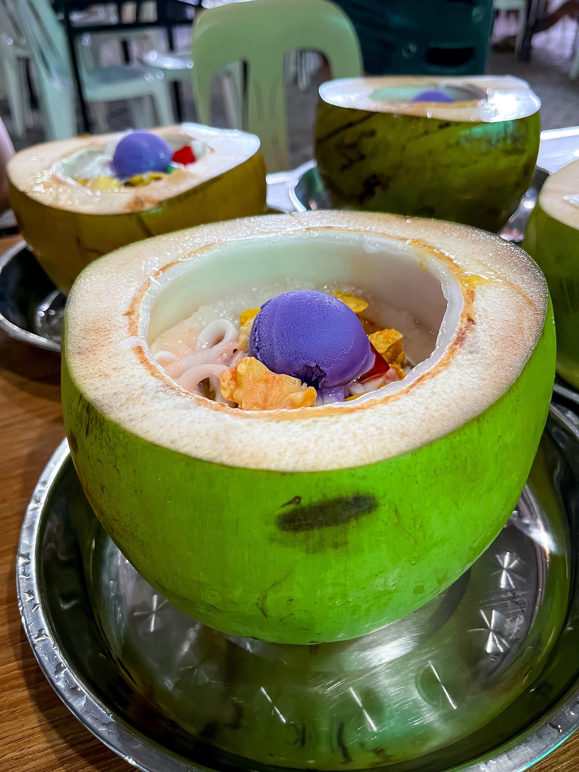 Shaved ice mixed with milk, fruit and ice cream and served in a fresh coconut