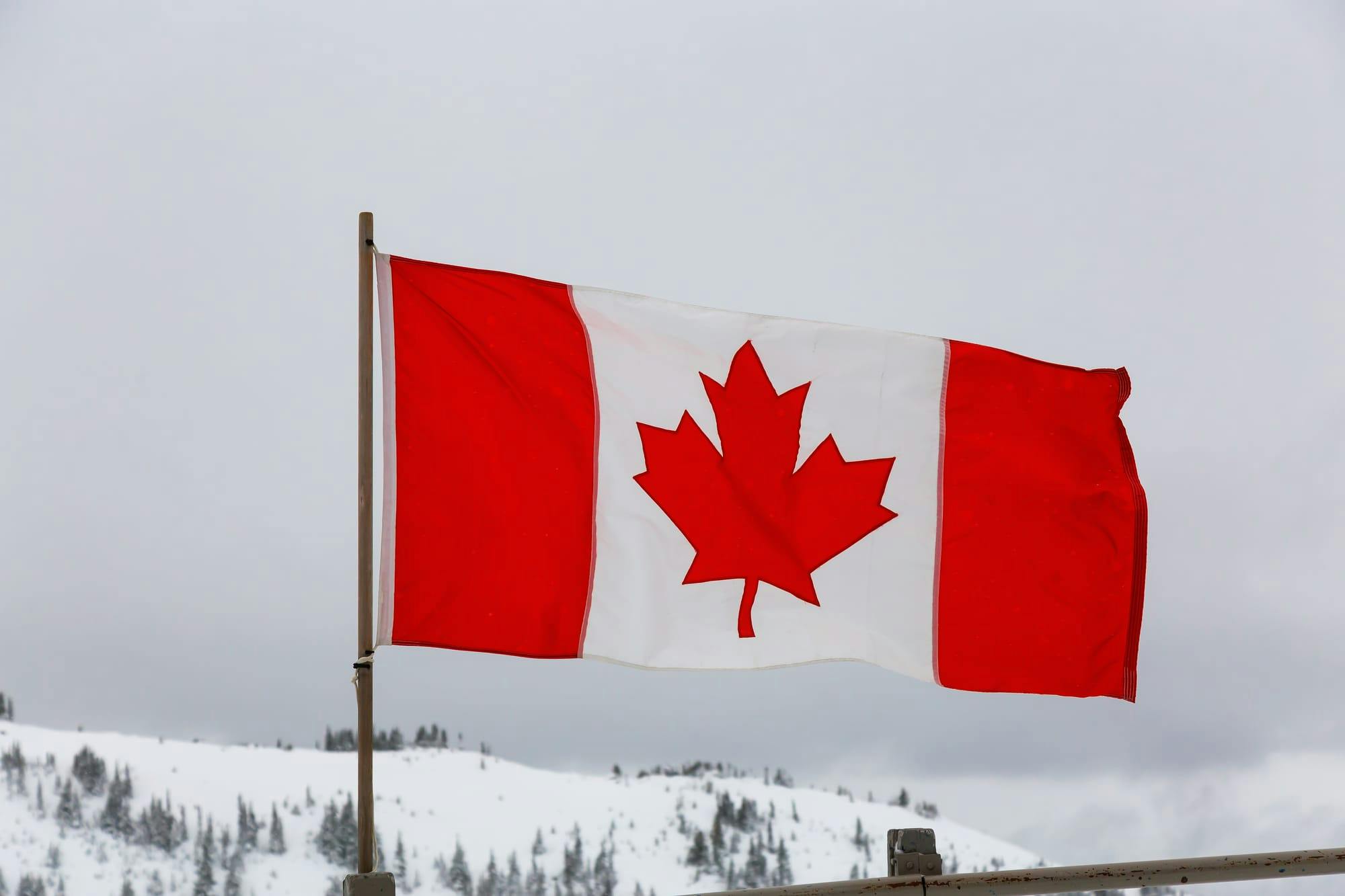 Canadian flag with a snowy backdrop