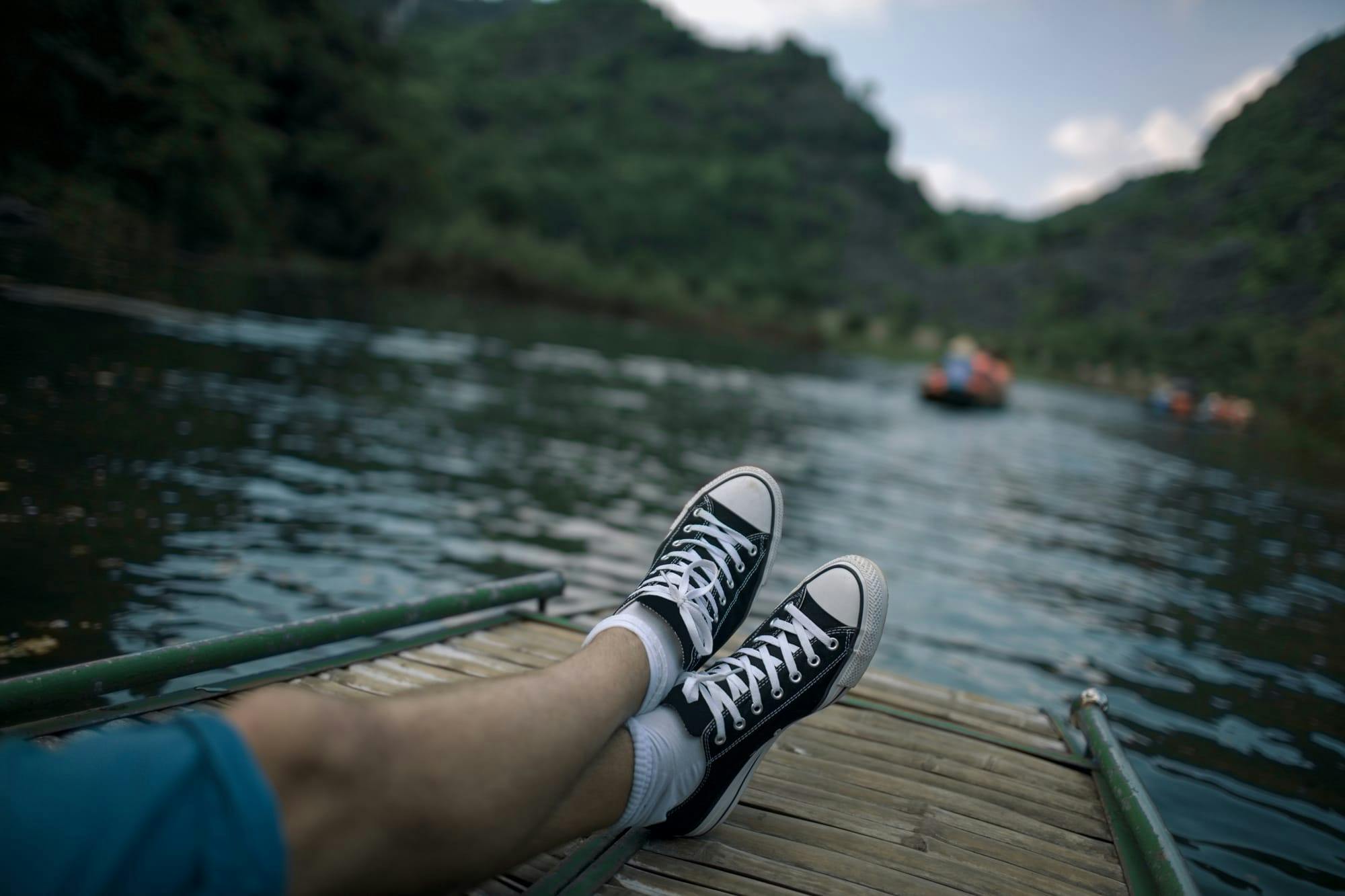 person relaxing on a pier overlooking a lake
