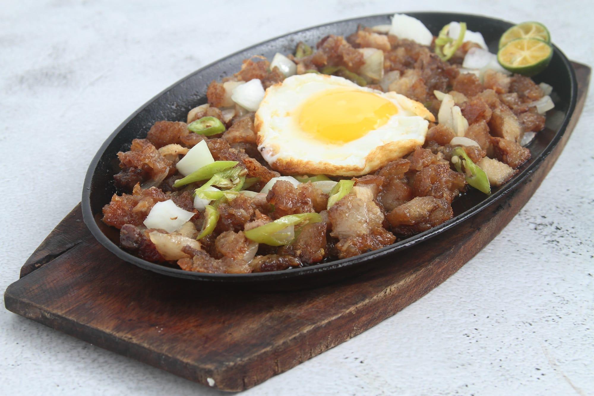 Plate of crispy fried meat with an egg on top