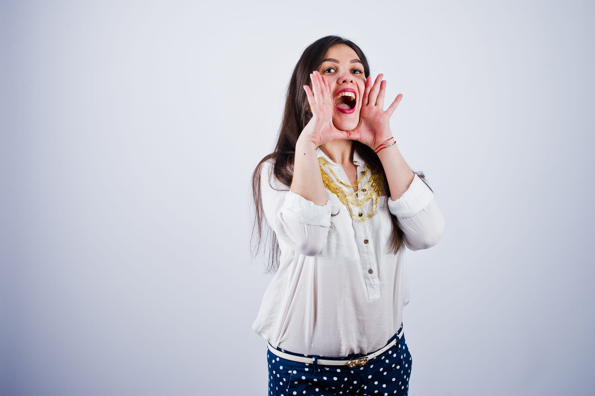 woman with hands near their mouth as if yelling